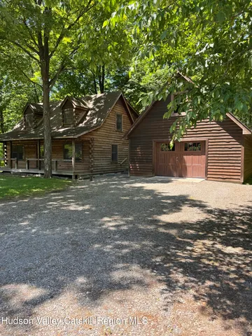 a backyard of a house with large trees and brick walls