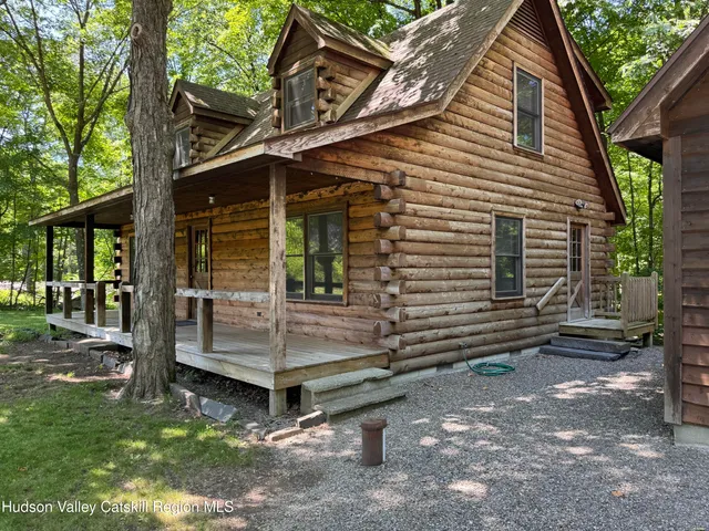 a view of a house with a yard and wooden fence