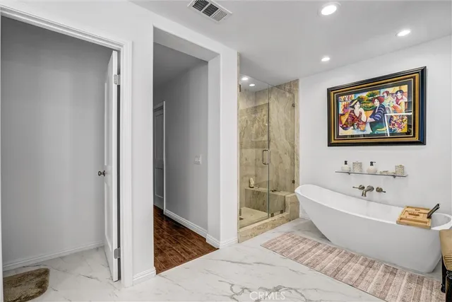 a spacious bathroom with a bathtub and shower