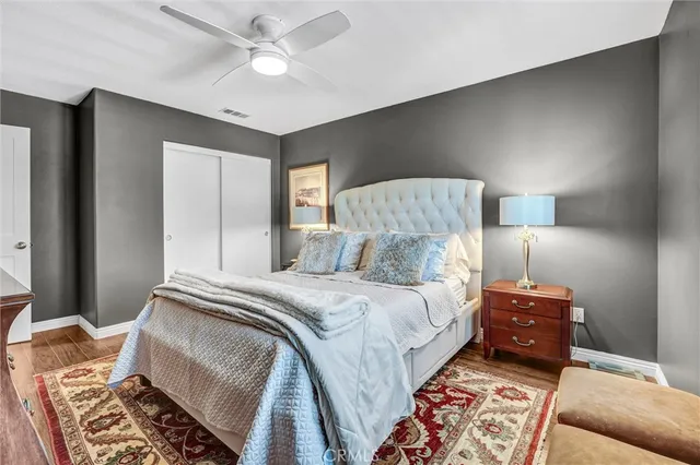 a bedroom with a bed and a lamp