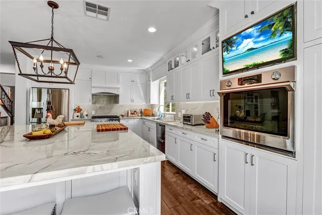 a kitchen with stainless steel appliances granite countertop a stove and cabinets