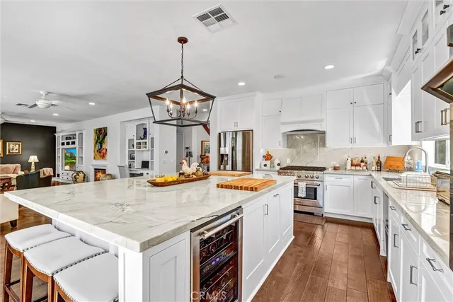 a large kitchen with kitchen island a sink counter space and stainless steel appliances