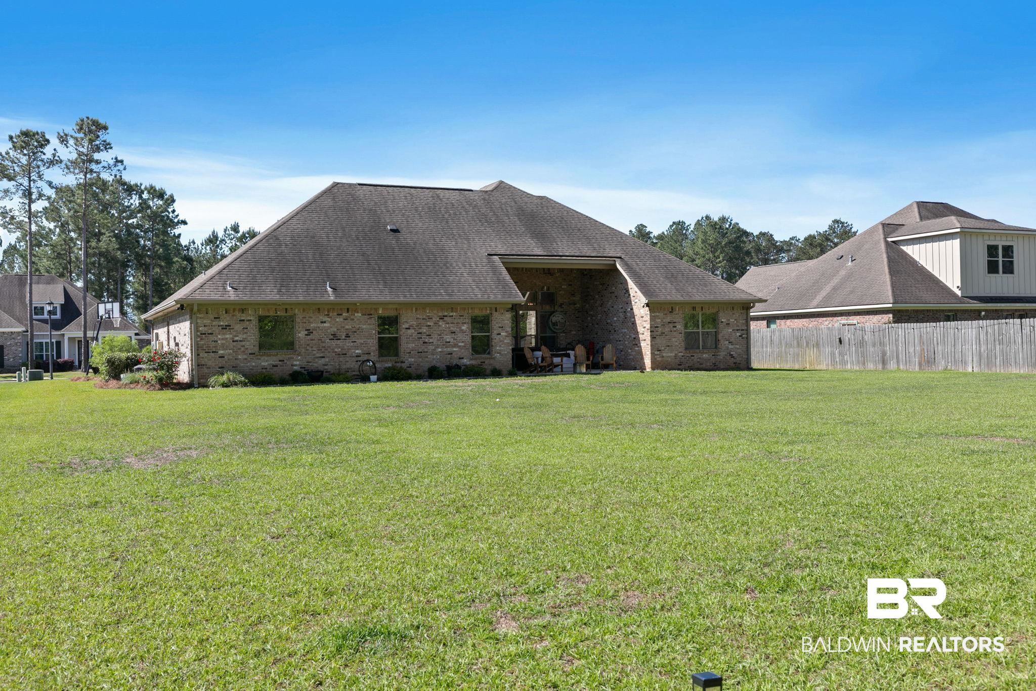 31911 Bobwhite Road Daphne, AL 36527 - Photo 52 of 85 Rear view of property featuring a patio area, brick siding, and a shingled roof