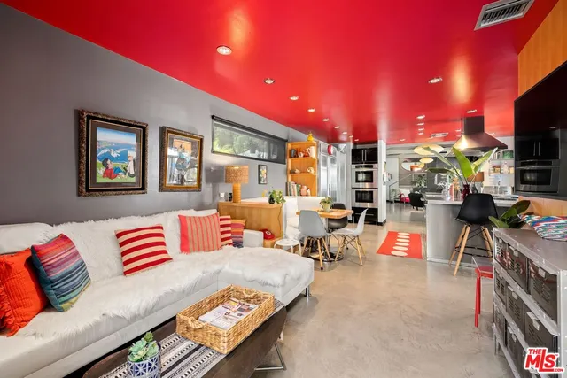 a living room with furniture a flat screen tv and a couch