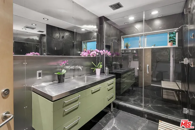 a kitchen with stainless steel appliances kitchen island granite countertop a sink and cabinets