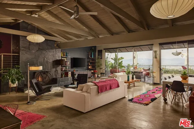 a living room with furniture and a floor to ceiling window