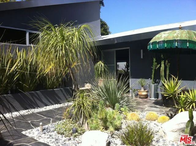 a view of front door and potted plants