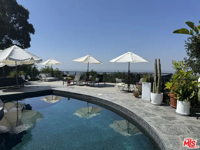 a swimming pool with outdoor seating yard and outdoor seating