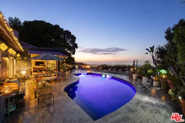 a view of a swimming pool with outdoor seating