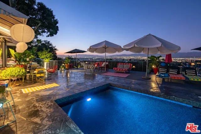 a view of a swimming pool with sitting area