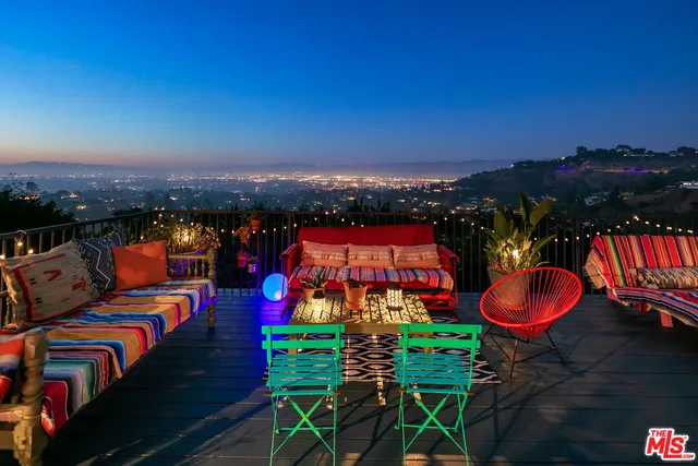 a view of a balcony with outdoor seating