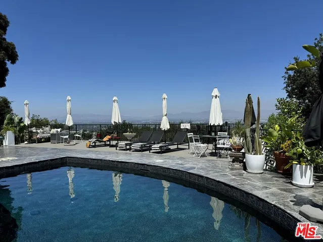 a view of swimming pool with outdoor seating