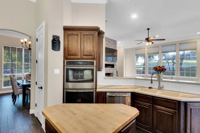 a kitchen with kitchen island a sink appliances and a counter top space