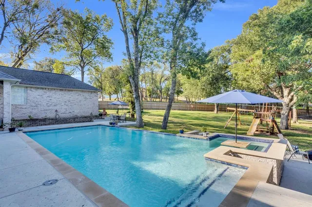 a view of a swimming pool with a patio