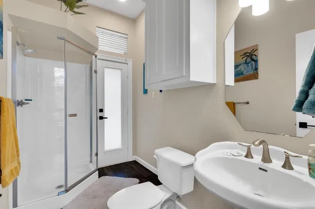a bathroom with a sink toilet and shower
