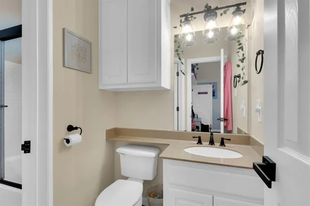 a bathroom with a sink toilet and shower