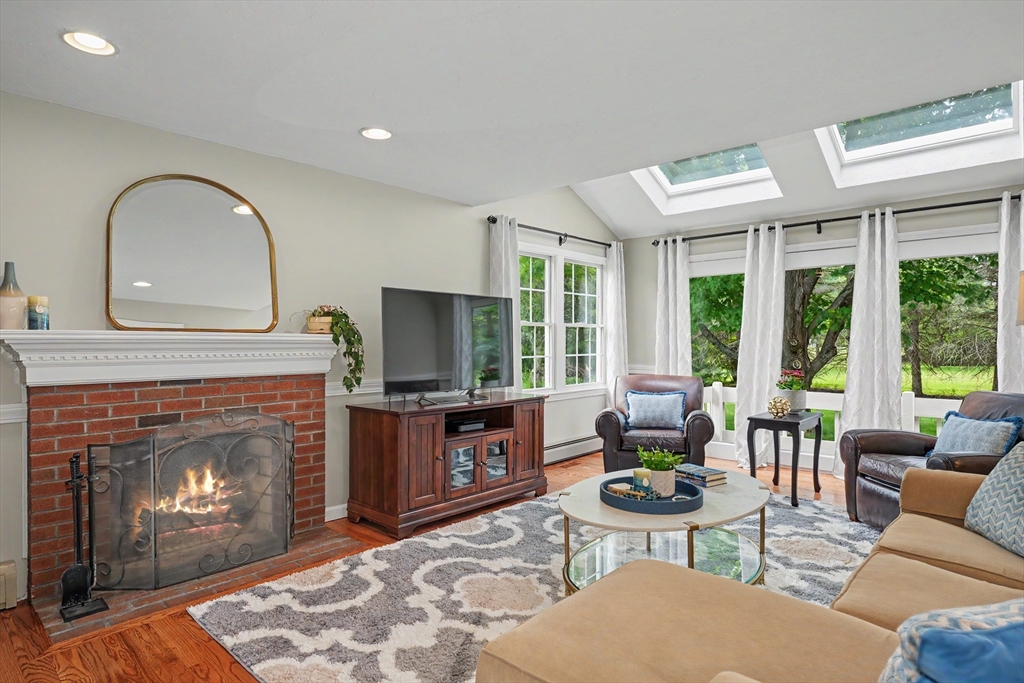 15 Lanthorn Road Northborough, MA 01532 - Photo 5 of 37 a living room with fireplace a large window and a fireplace