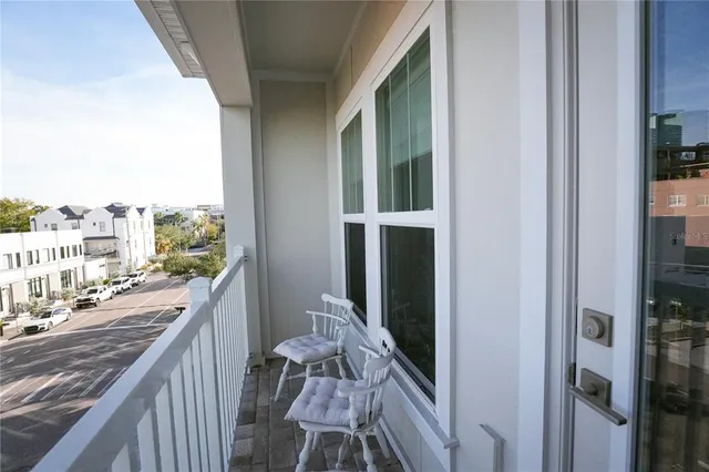 a view of a balcony with furniture