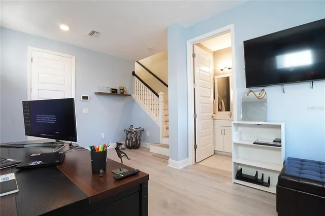 a kitchen with stainless steel appliances kitchen island granite countertop a refrigerator a sink and a stove