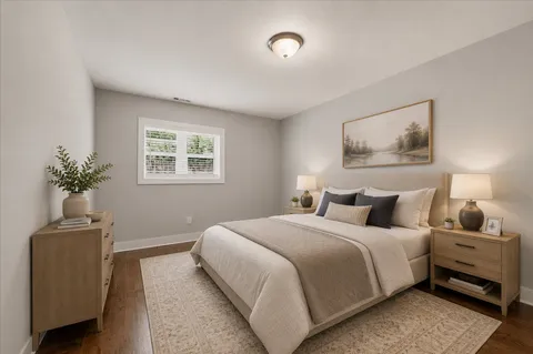 a bedroom with a bed and a potted plant