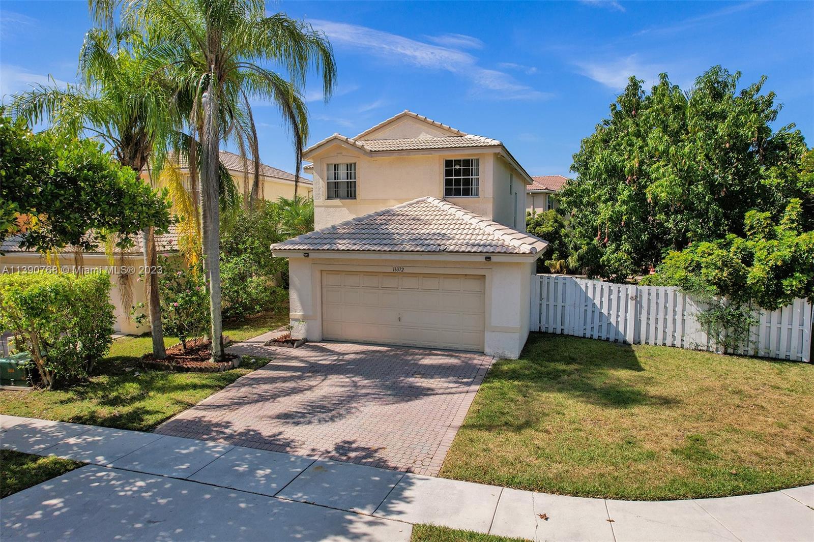Silver Shores Miramar, FL 33027 - Photo 1 of 30 a front view of a house with a yard and garage