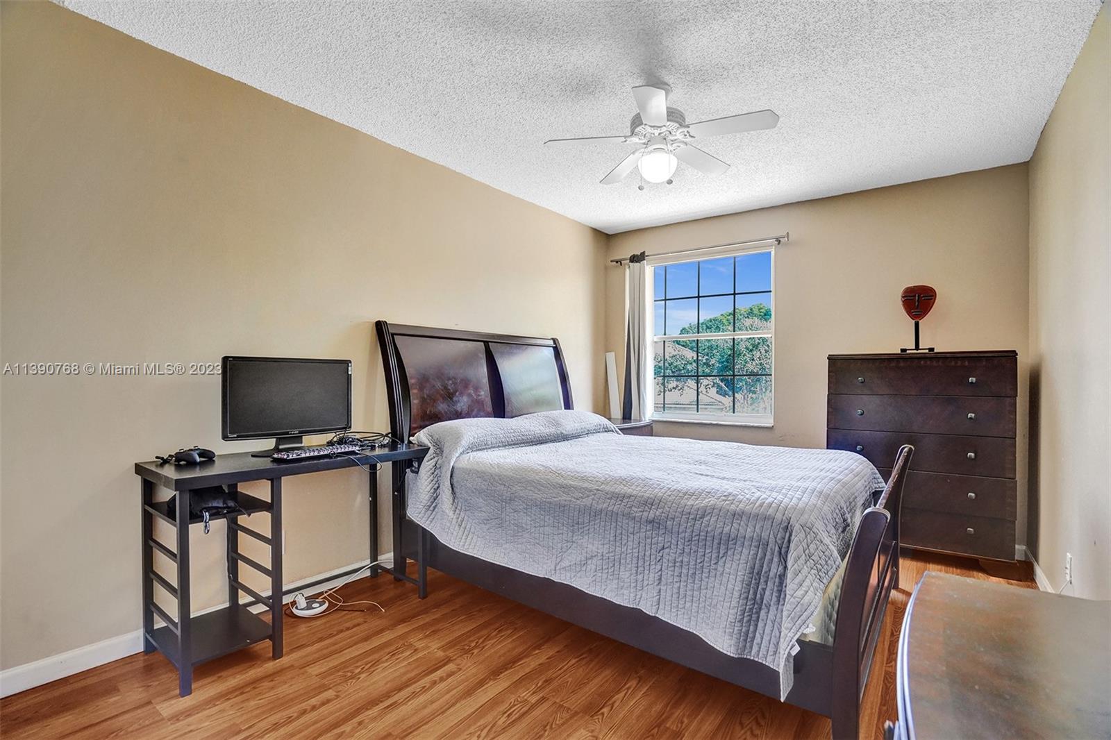 Silver Shores Miramar, FL 33027 - Photo 14 of 30 a bedroom with a bed and a chandelier