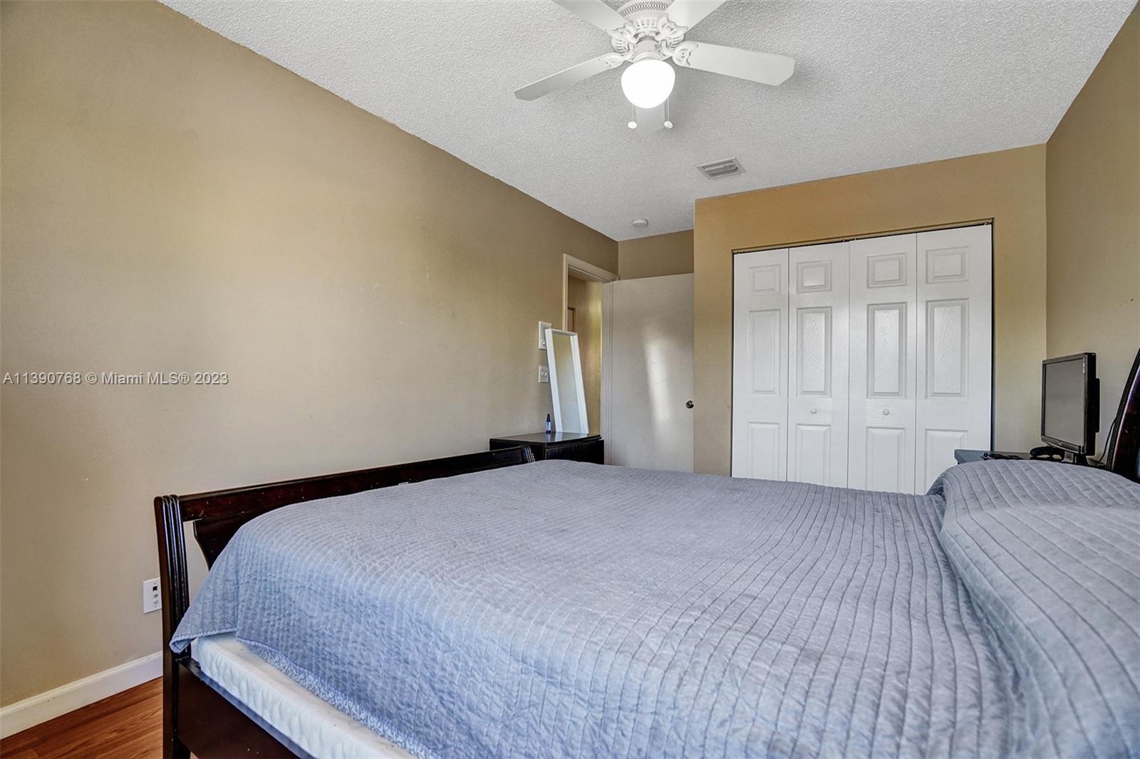 Silver Shores Miramar, FL 33027 - Photo 15 of 30 a bedroom with a large bed and a chandelier