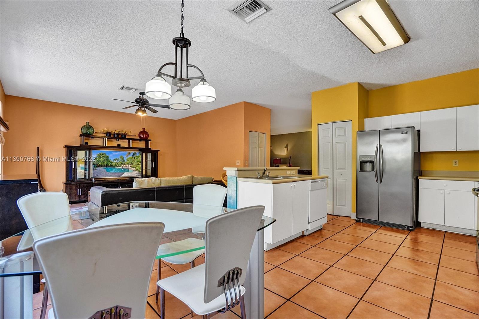 Silver Shores Miramar, FL 33027 - Photo 22 of 30 a view of a dining room with furniture a chandelier and wooden floor