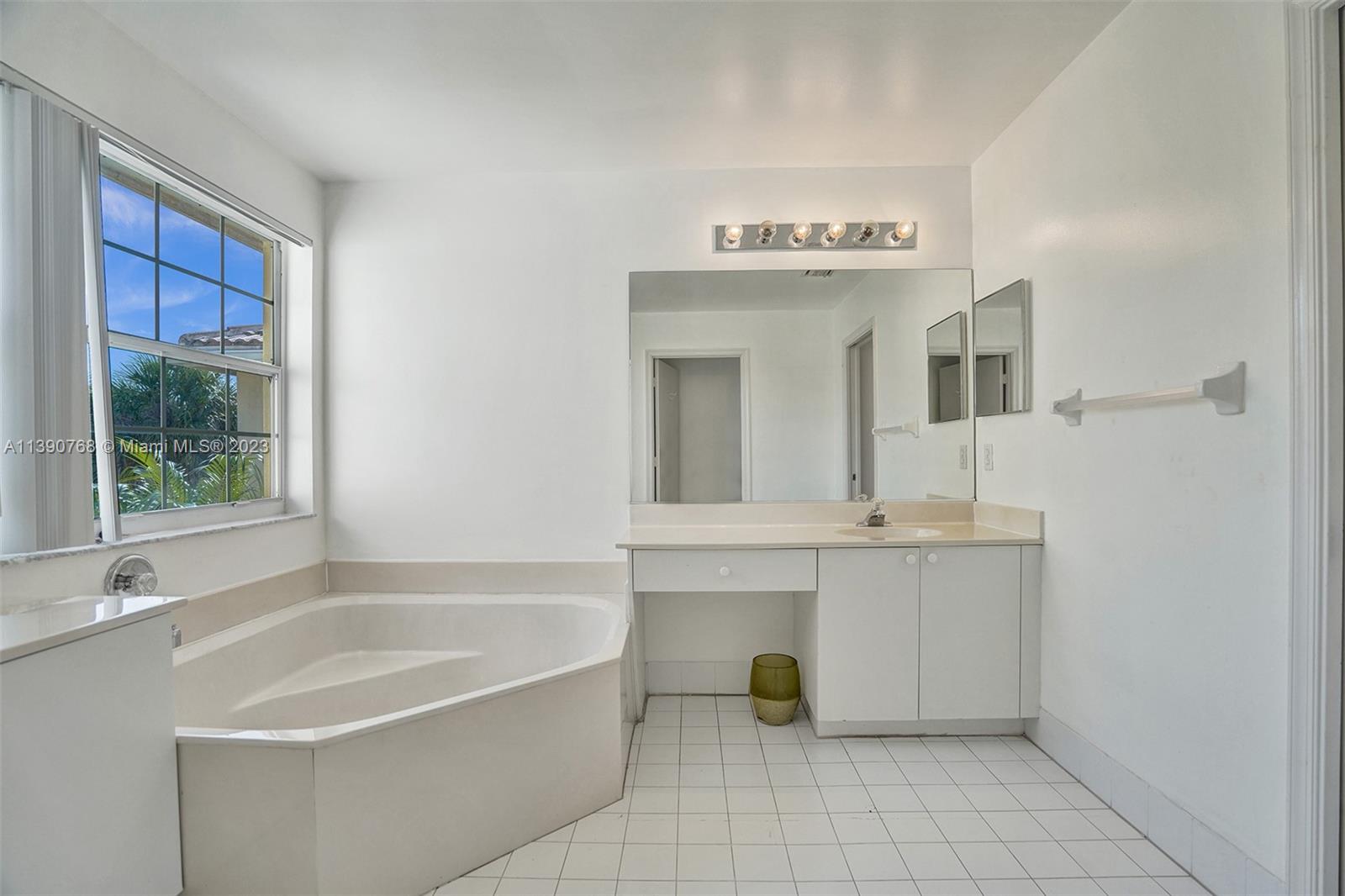 Silver Shores Miramar, FL 33027 - Photo 10 of 30 a spacious bathroom with a tub sink and mirror