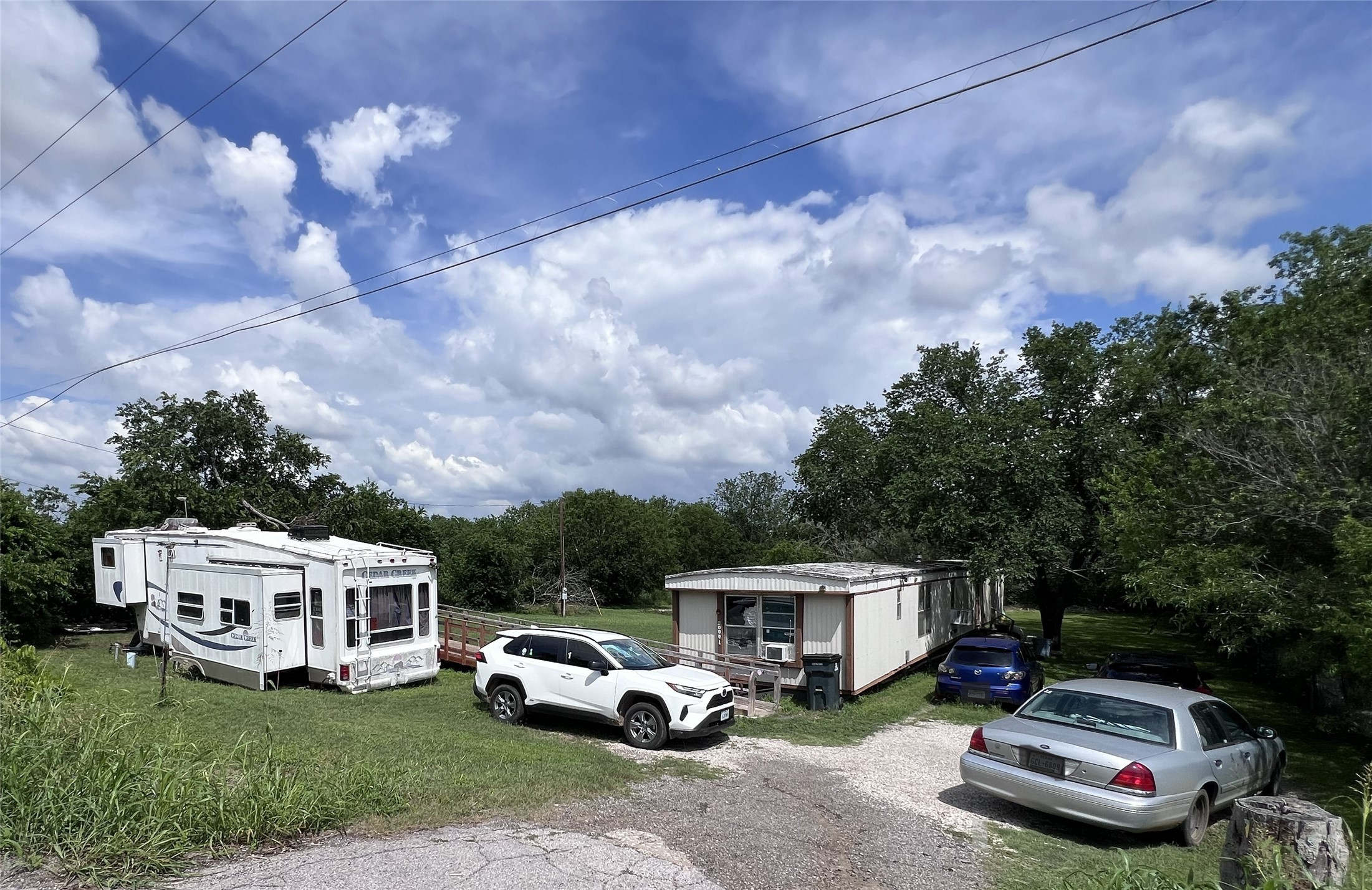 10001 Peterson Road Del Valle, TX 78617 - Photo 1 of 29 a car parked in front of a white house