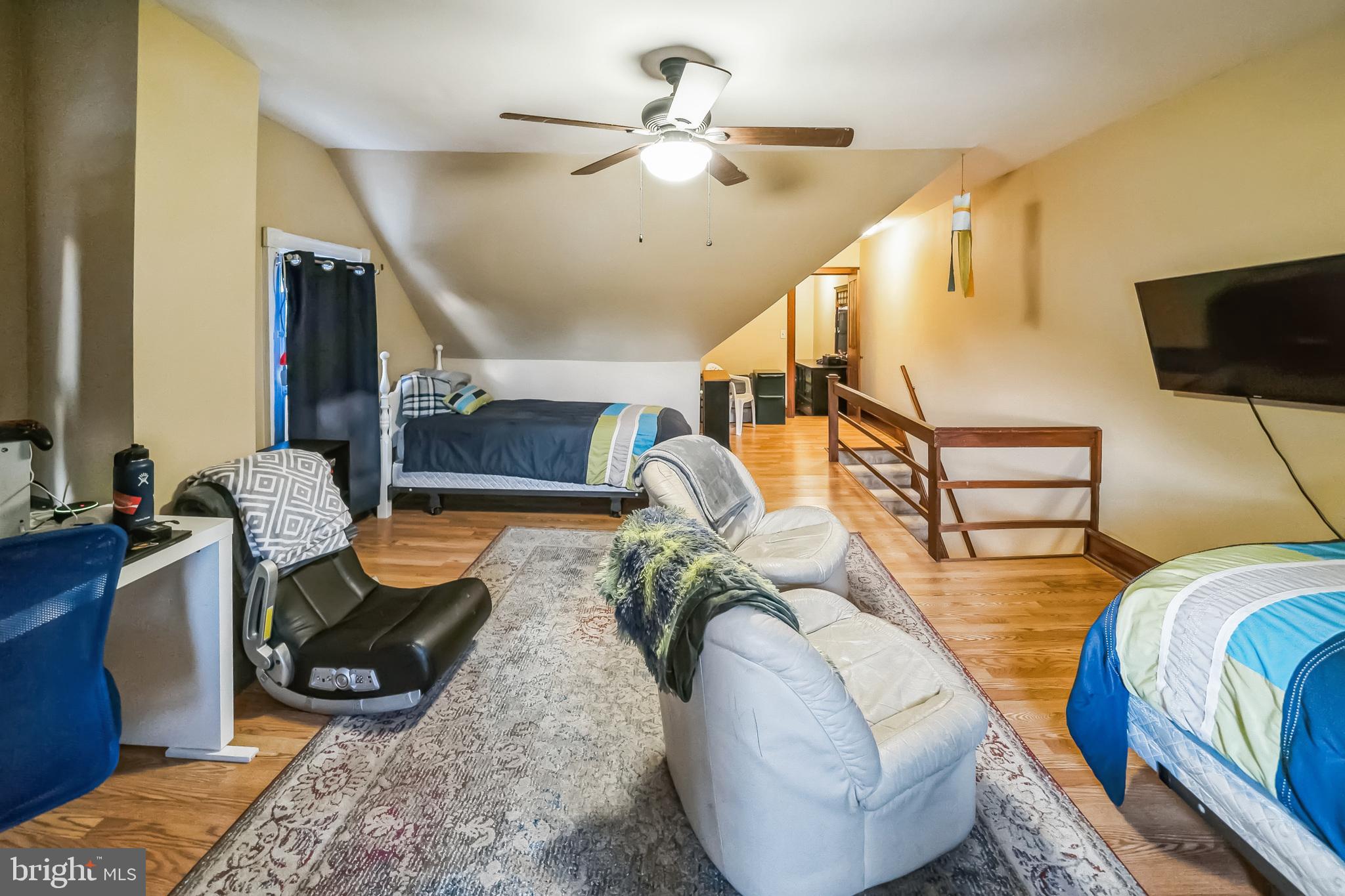 59 Cherry Street Hatfield, PA 19440 - Photo 22 of 30 a living room with furniture a flat screen tv and a chandelier