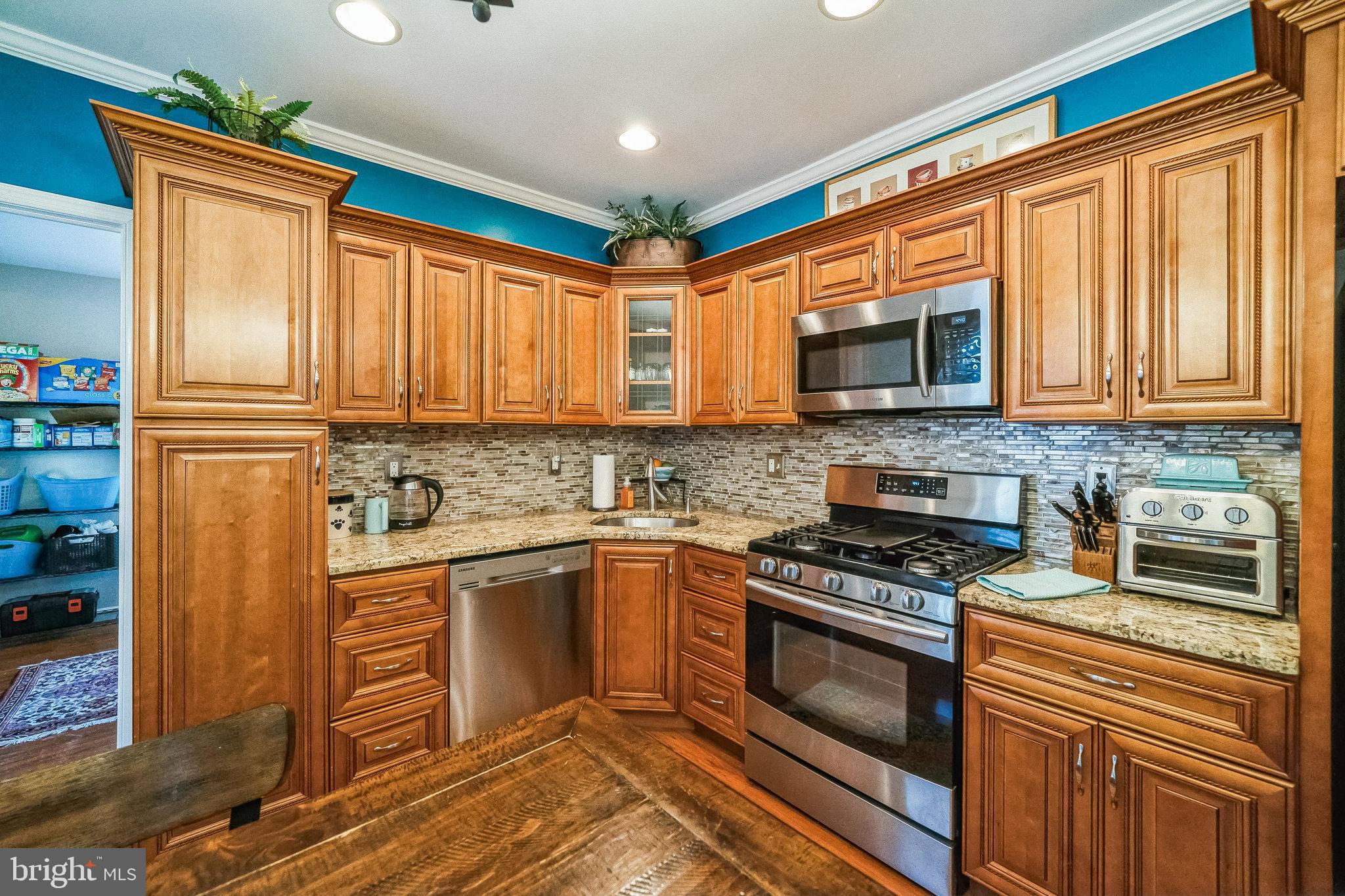 59 Cherry Street Hatfield, PA 19440 - Photo 4 of 30 a kitchen with stainless steel appliances granite countertop a stove top oven a sink dishwasher and a microwave oven with cabinets