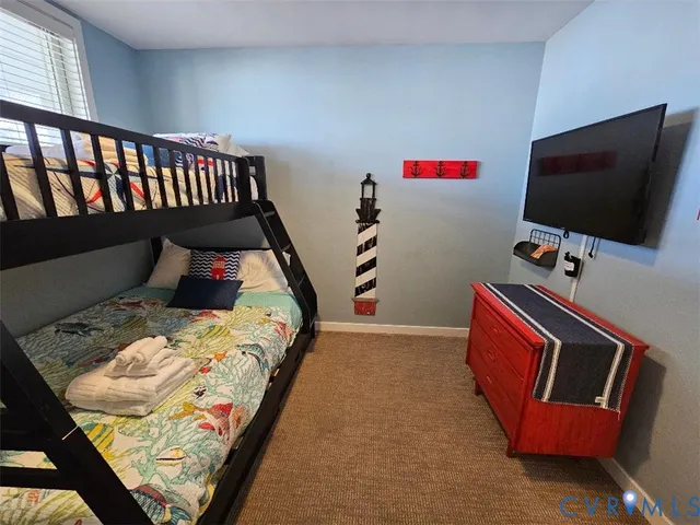 a bed sitting in a bedroom and tv