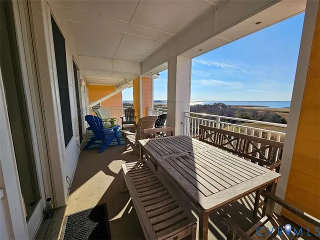 a view of a living room with furniture and floor to ceiling window