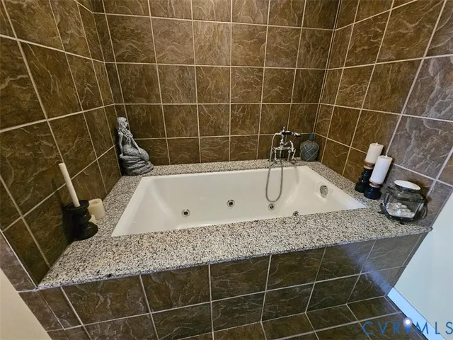 a bathroom with a granite countertop sink a toilet a mirror and vanity