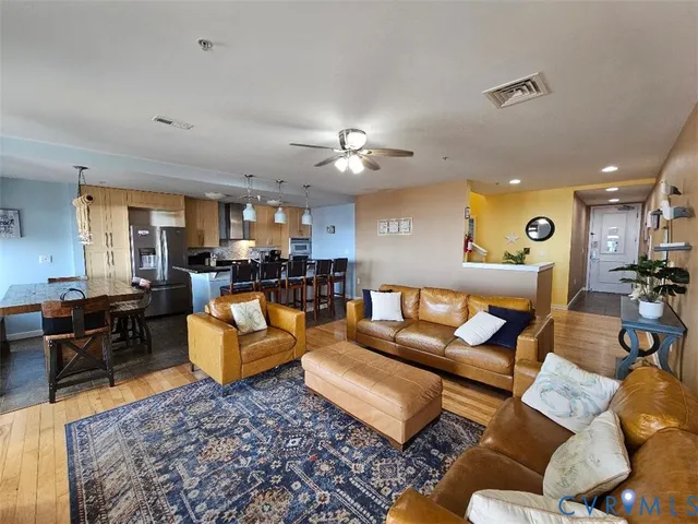 a living room with furniture kitchen view and a table