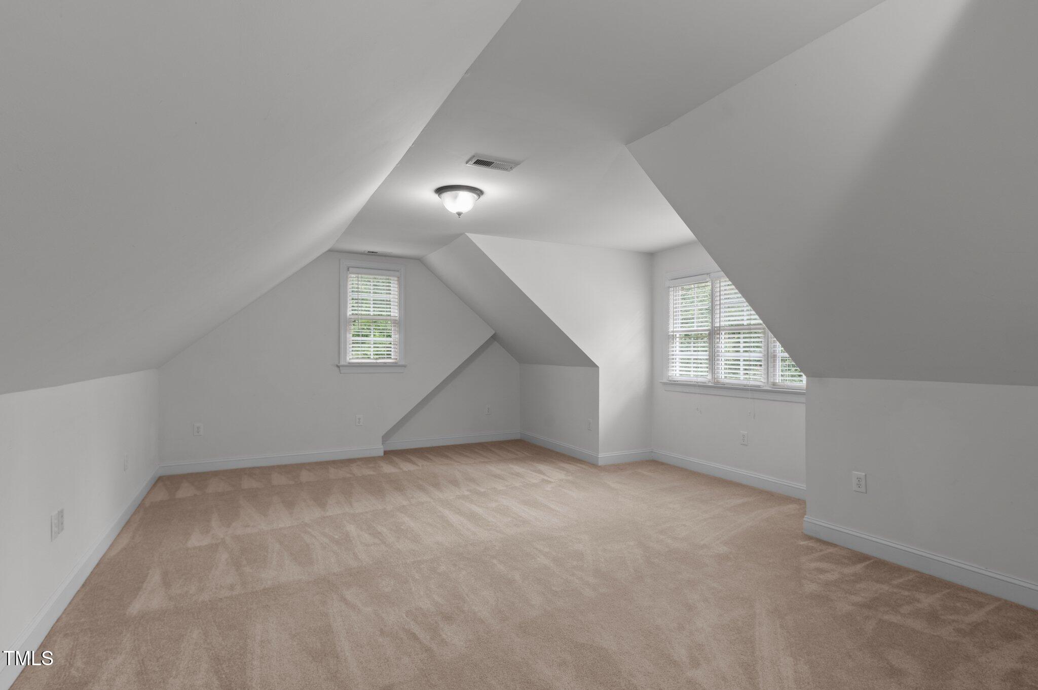 1012 Coram Fields Road Wake Forest, NC 27587 - Photo 9 of 38 an empty room with windows and ceiling fan view