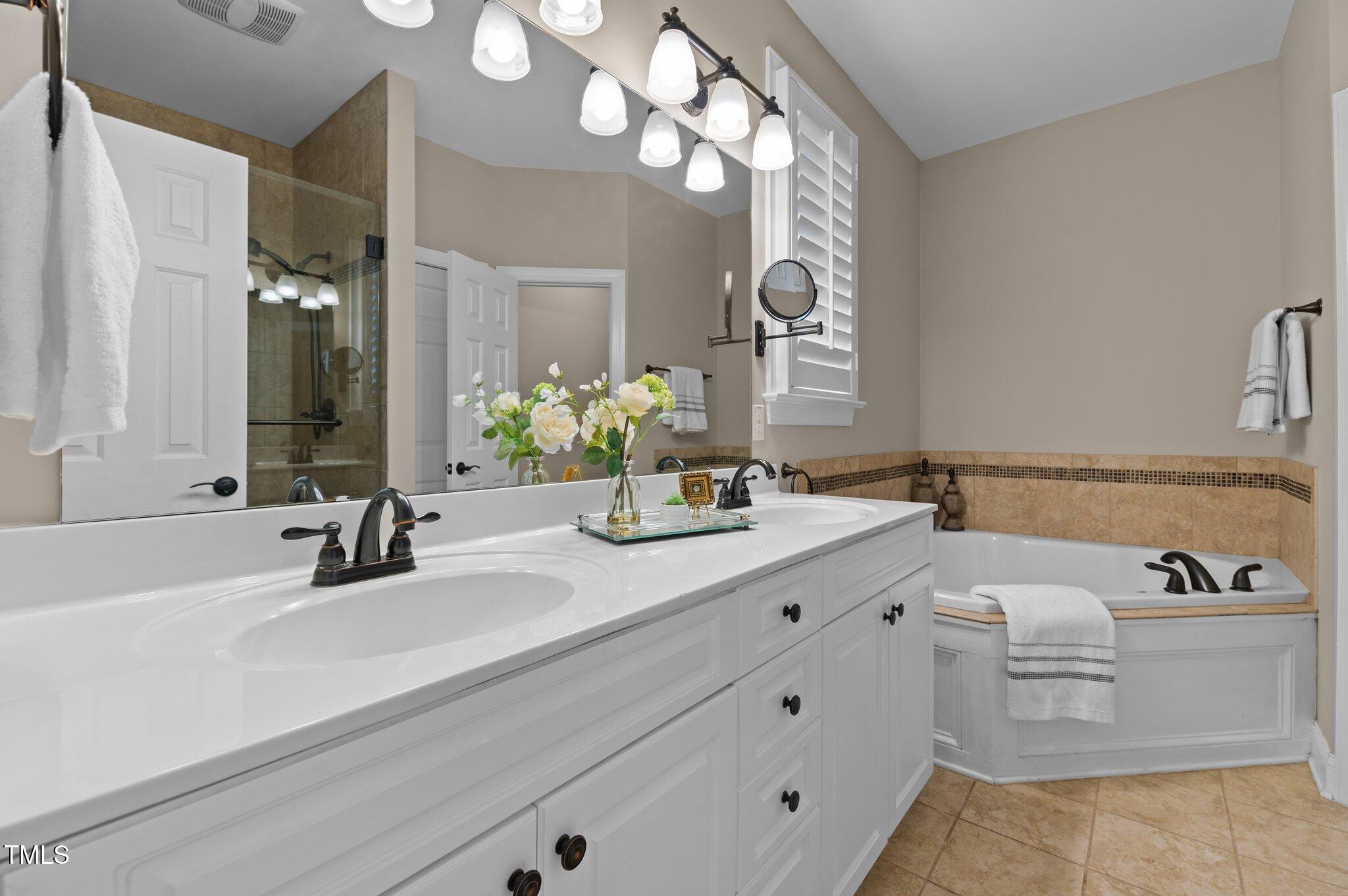 1012 Coram Fields Road Wake Forest, NC 27587 - Photo 18 of 38 a bathroom with a sink and a mirror