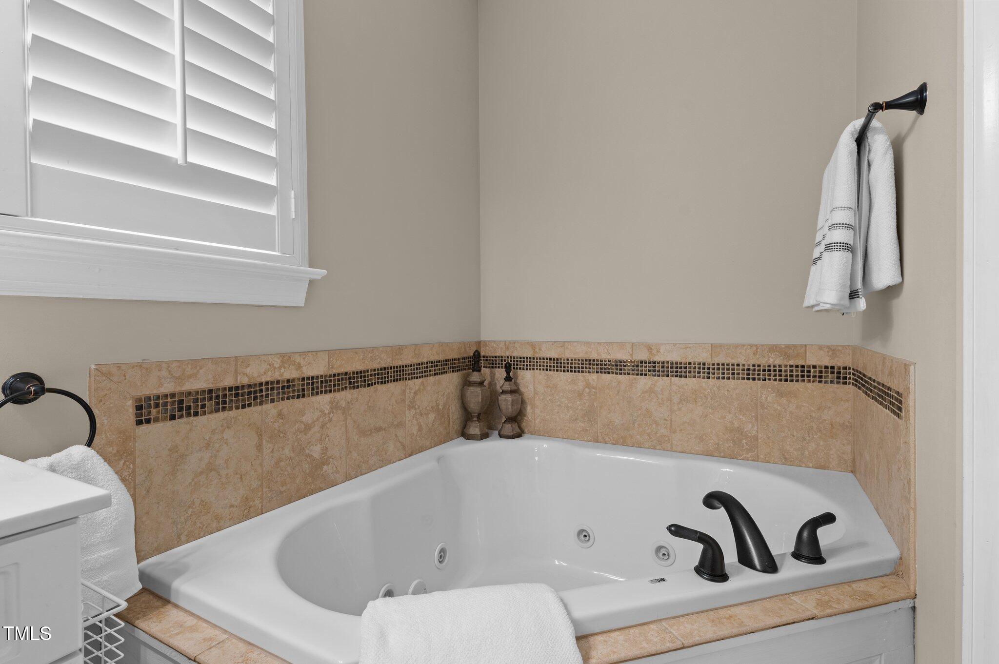 1012 Coram Fields Road Wake Forest, NC 27587 - Photo 19 of 38 a bathroom with a bathtub