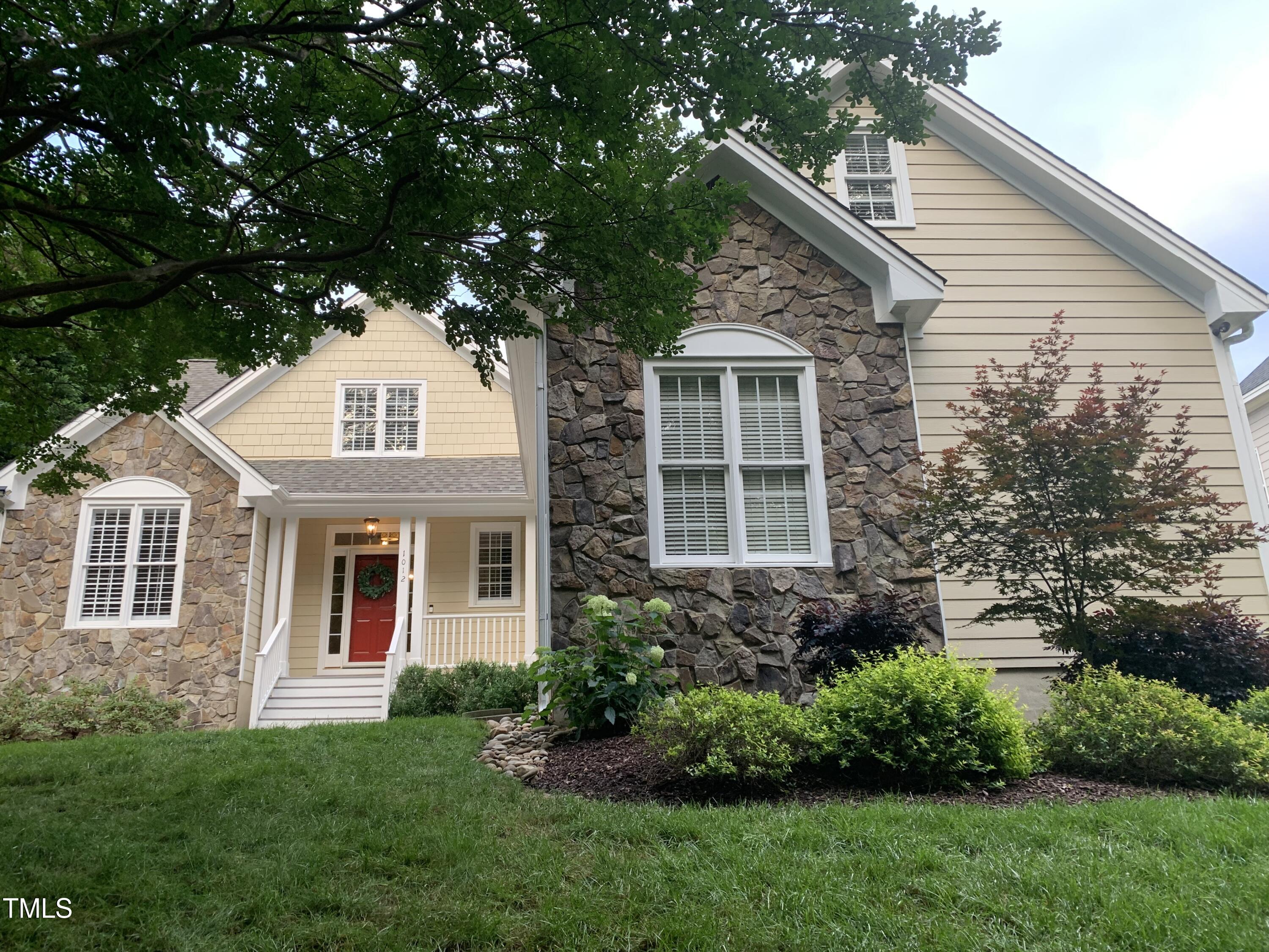 1012 Coram Fields Road Wake Forest, NC 27587 - Photo 32 of 38 a front view of a house with a garden