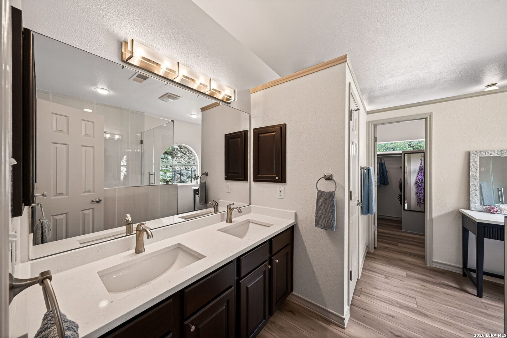 17431 Helotes Spring Road Helotes, TX 78023 - Photo 25 of 50 a bathroom with a double vanity sink a mirror and shower