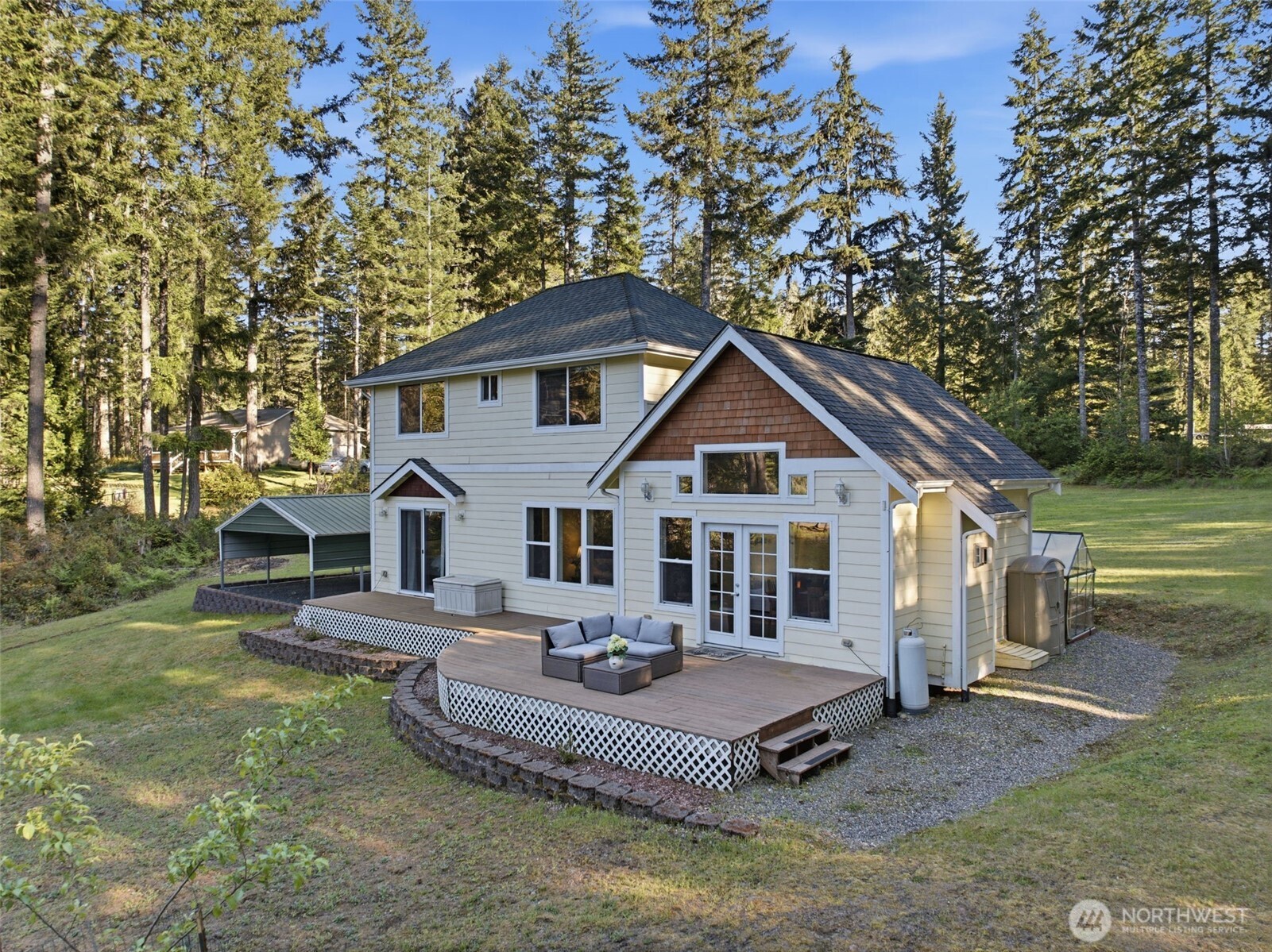 6971 Northeast Tahuya Blacksmith Road Belfair, WA 98528 - Photo 4 of 38 a front view of a house with a yard
