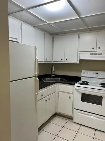 a white refrigerator freezer sitting inside of a kitchen