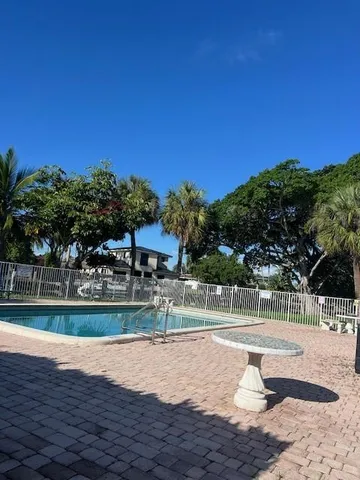 a view of a swimming pool with a yard