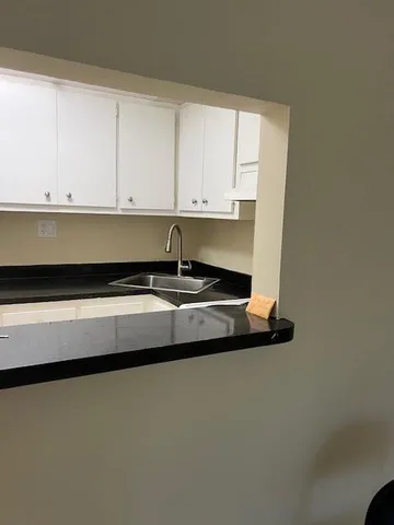 a kitchen with a sink and cabinets