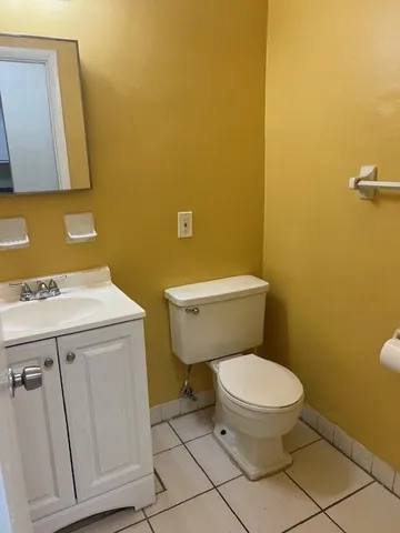 a white toilet sitting next to a bathroom sink