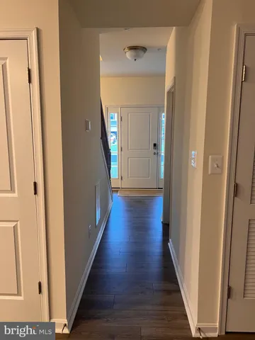 a view of a hallway with wooden floor