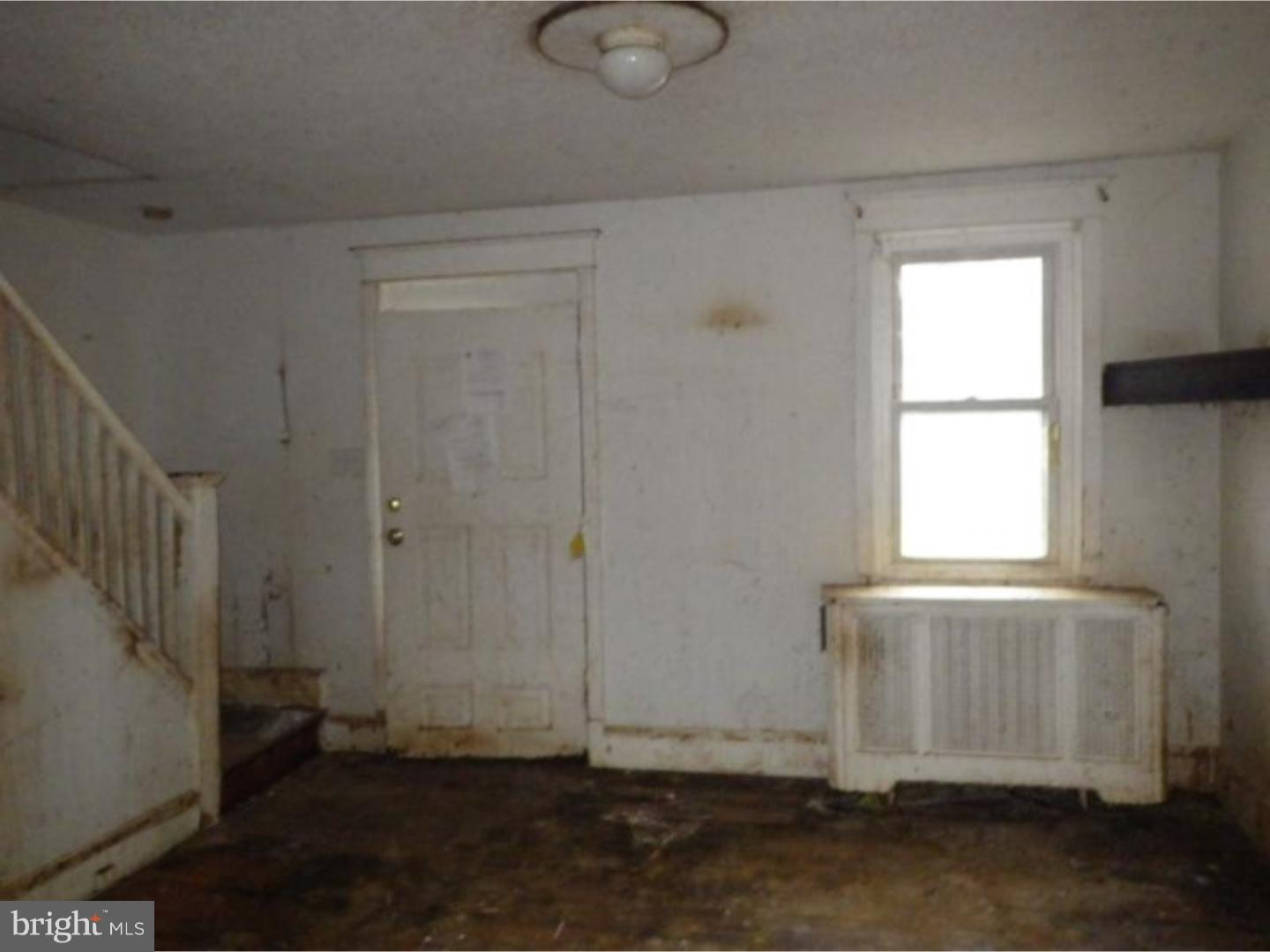 634 Littlecroft Road Upper Darby, PA 19082 - Photo 2 of 9 an empty room with wooden floor and windows