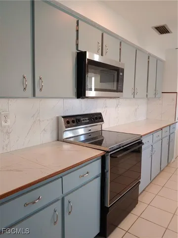 a kitchen with stainless steel appliances granite countertop a refrigerator a sink and dishwasher