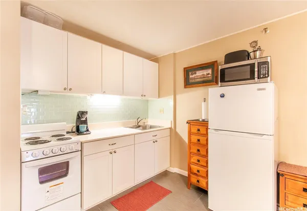 a kitchen with a white cabinets and white appliances